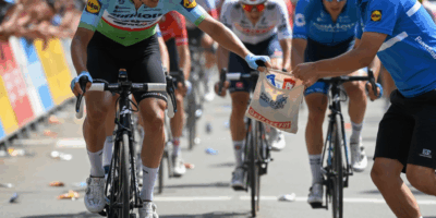 Cyclist grabbing a musette bag at the feed zone during a race
