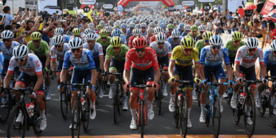 Cyclists lined up at the start line of a road race